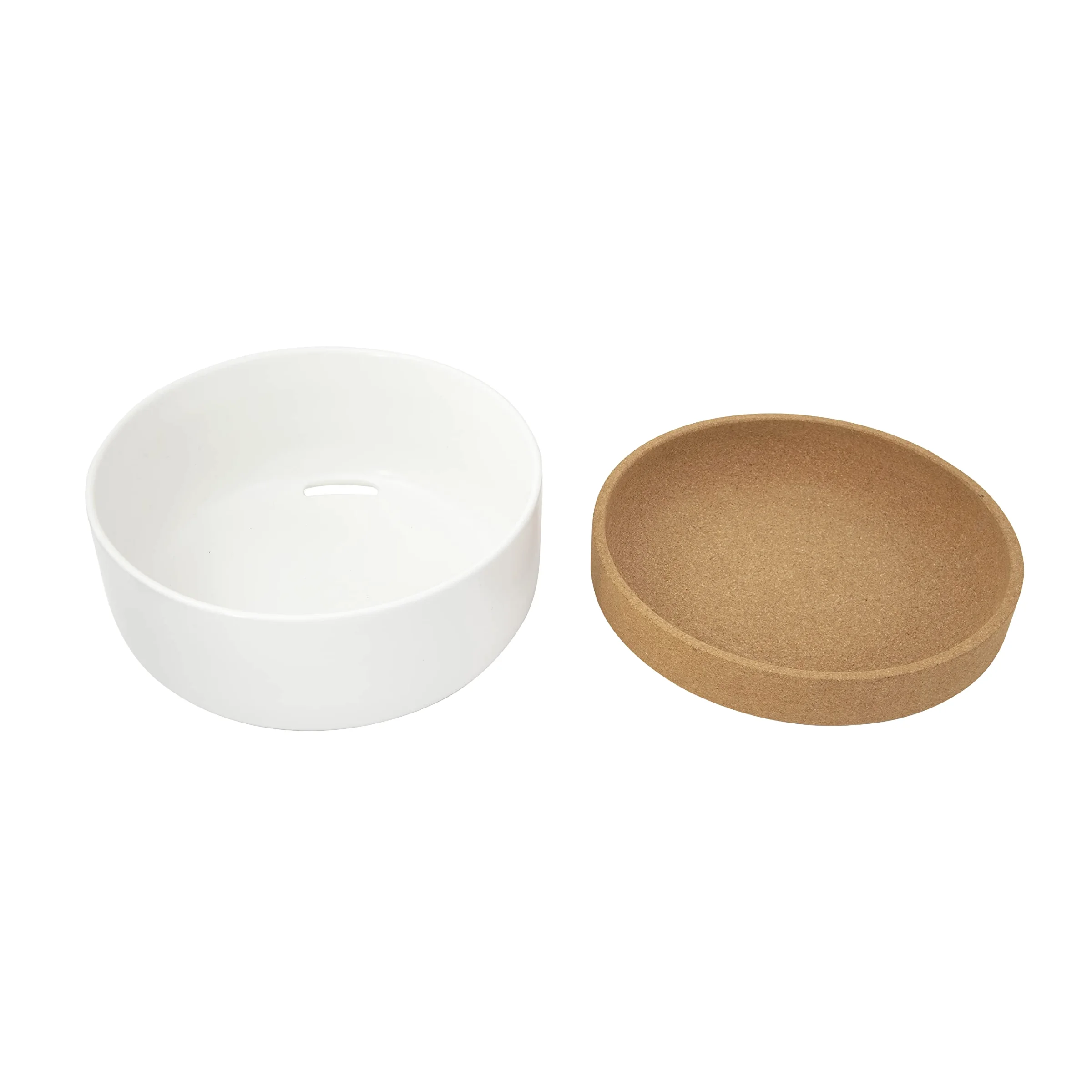 The white ceramic base of the Kamenstein produce bowl, an opening in its floor, with the cork tray lifted off beside it.