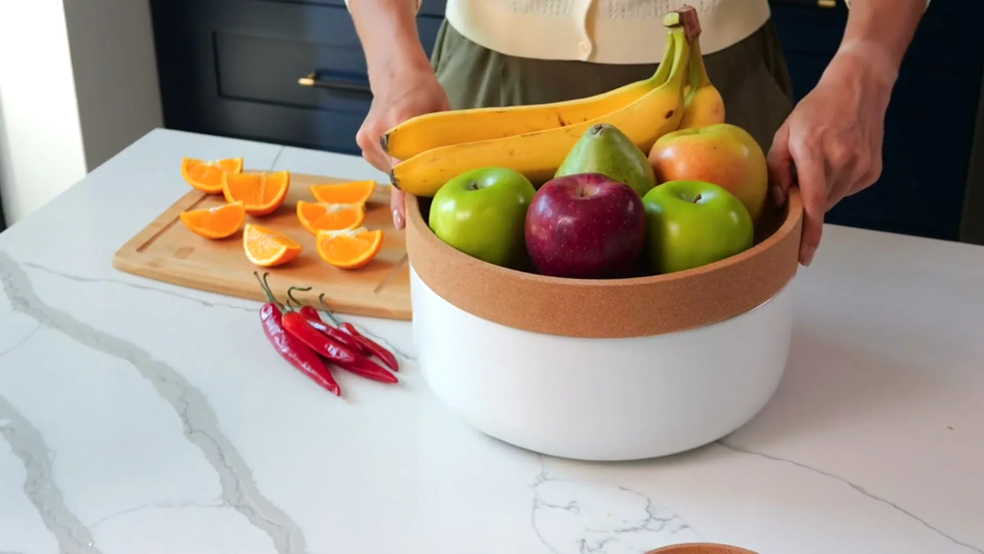 A fruit bowl lifted off the ceramic and cork base of the Kamenstein produce bowl