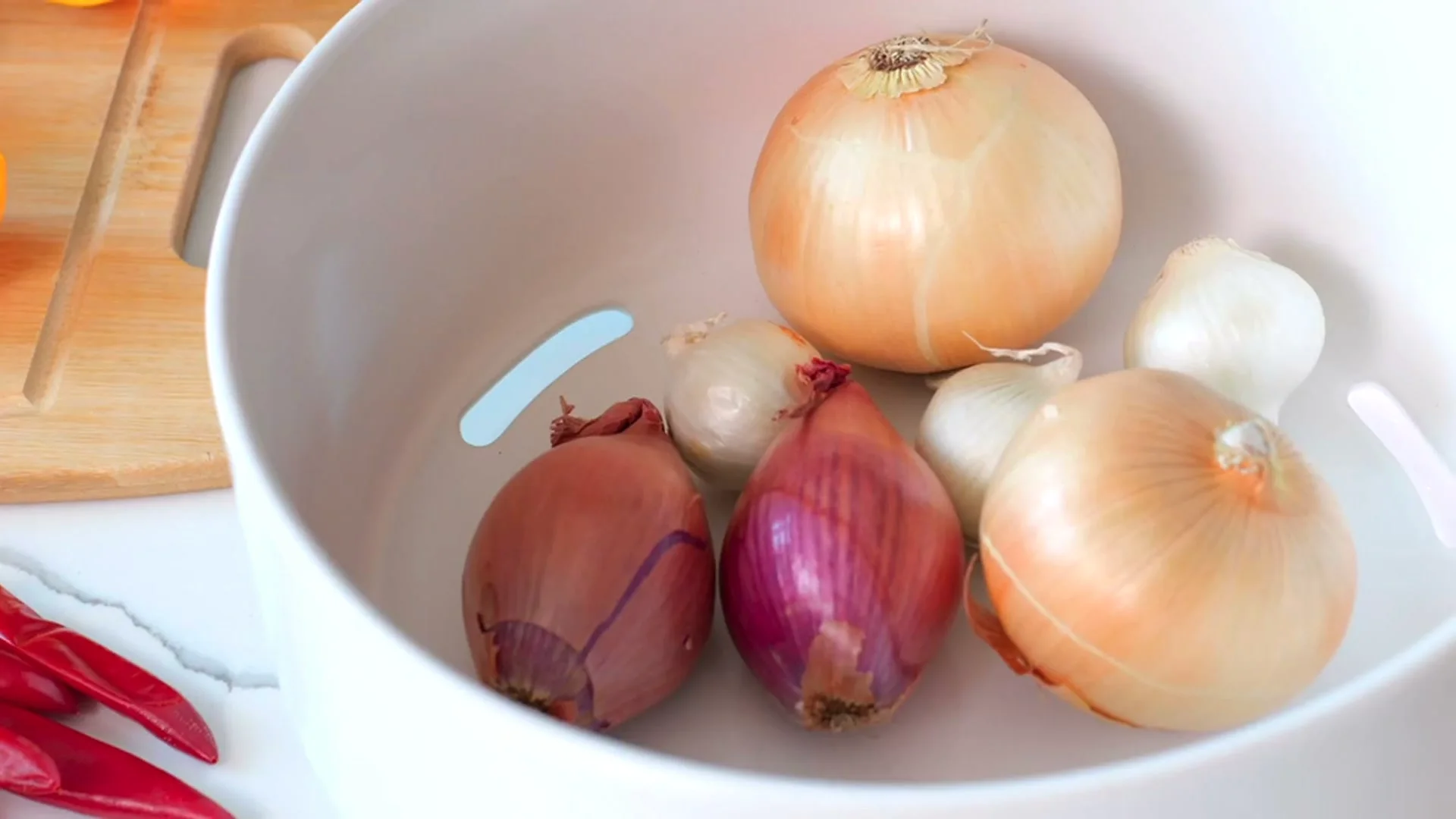 Onions in the vented ceramic base of the Ceramic and Cork produce bowl.